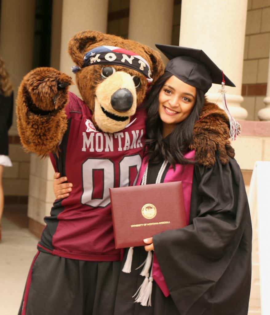 Sahar Qasem Muthna hugs Monte while holding her diploma from UM.