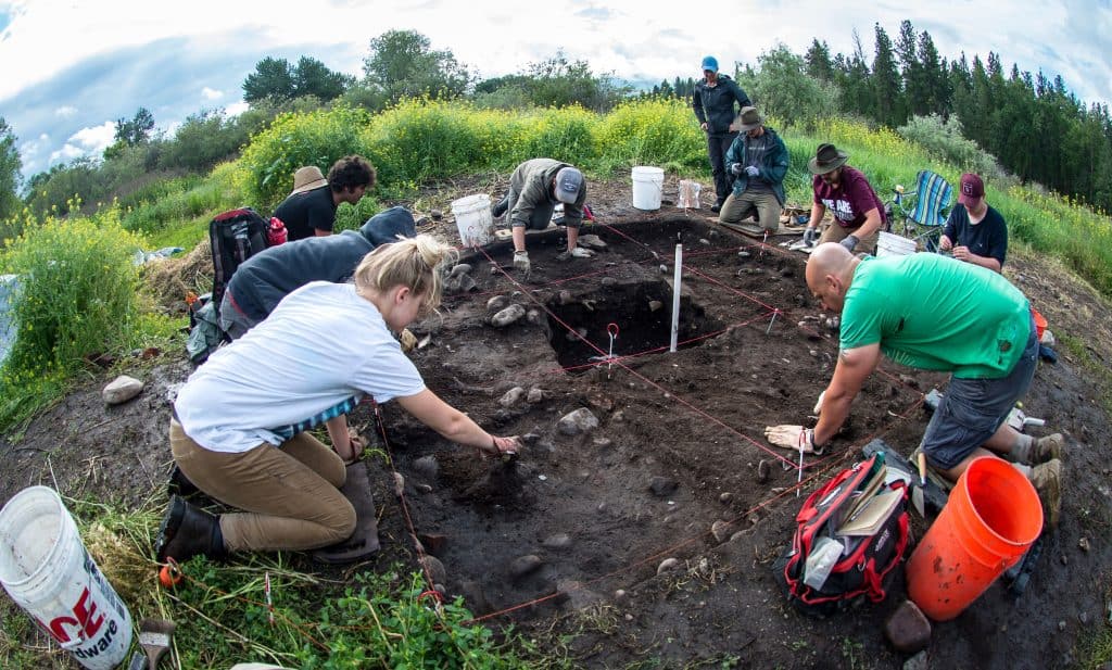 Anthropology students dig in the dirt near Fort Missoula.